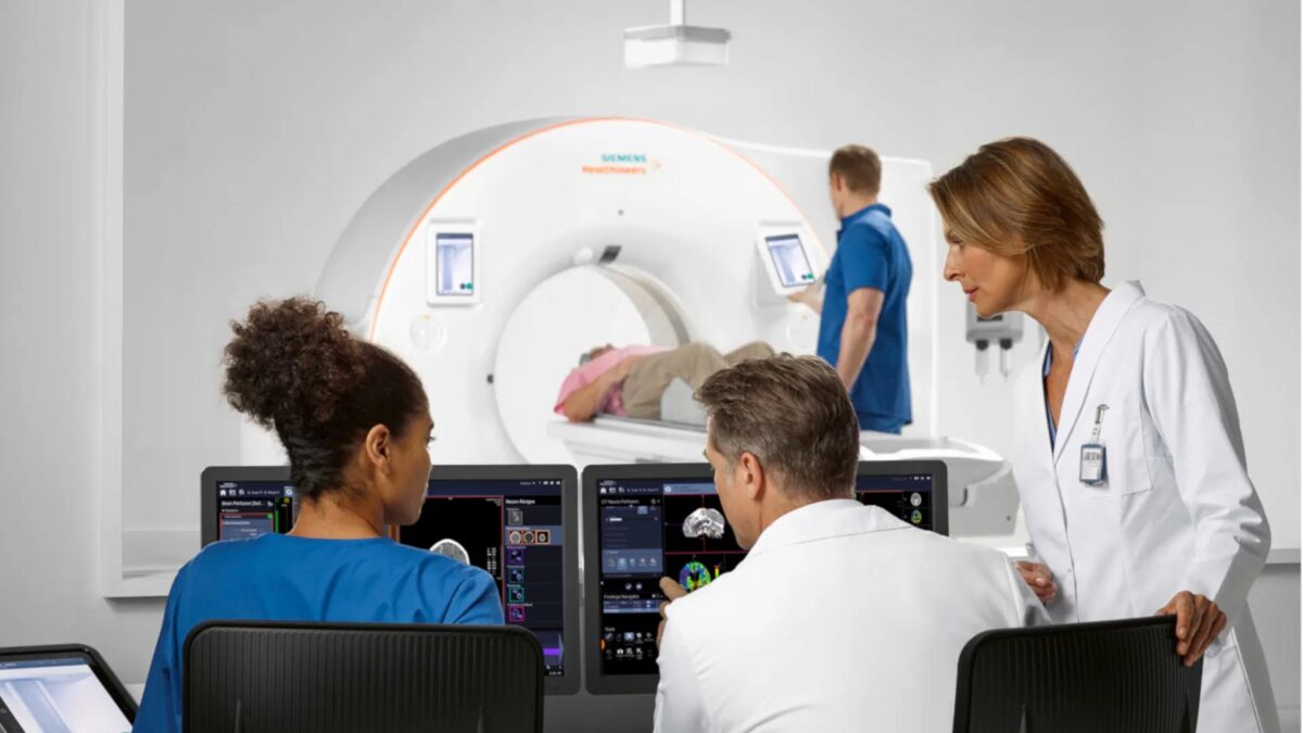 doctors assisting patient through ct simulation for radiation therapy